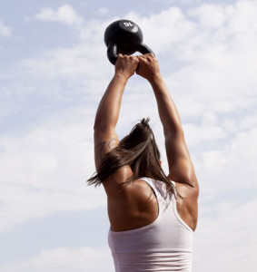 A woman lifting a weight above her head