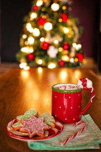 Hot chocolate and cookies in front of a Christmas tree