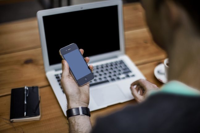 Person Using Phone and Computer