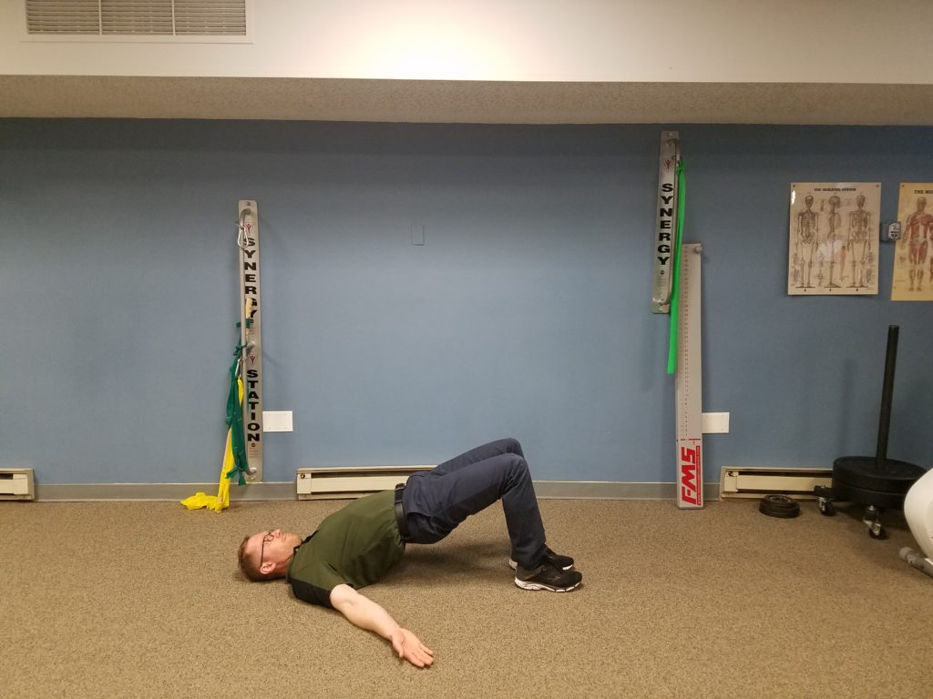 Bridge: Begin with knees bent, feet flat on the floor and a neutral lumbar curve. Press your hips up being sure to maintain the same curve in your low back as the beginning position. Perform 2 sets, 10-15 reps with 3sec hold.