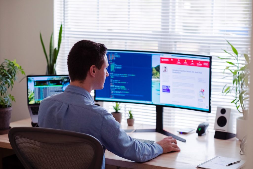 Person doing work on two computer screens