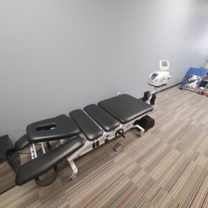 The inside of the Progressive Spine & Rehab Center office featuring a table for chiropractic care.